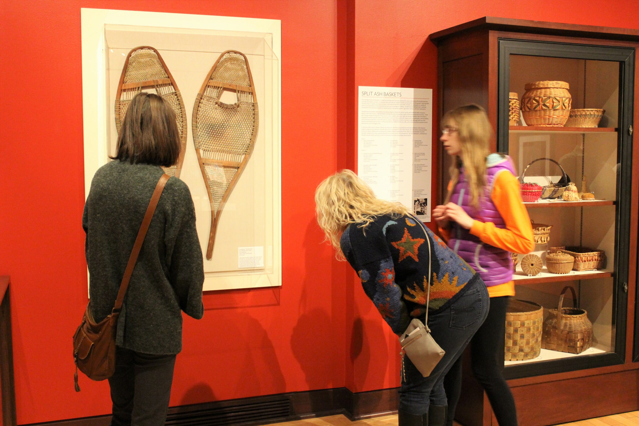 haudenosaunee iroquois gallery, 3 adults look closely at snowshoes